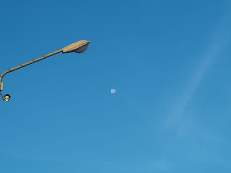 The street light tower on the background is blue sky And there is a small moon in the middle
Energy and nature concepts.
Minimal image.