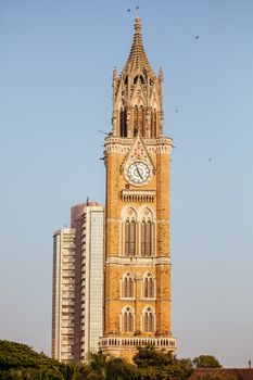 Rajabai Clock Tower and Bombay Stock Exchange Building on a clear evening in Mumbai India
