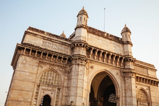 Mumbai, India - 9 November: The Gateway of India with tourists and sellers on a clear autumn evening