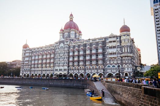 Mumbai, India - 9 November 2016: The Taj Mahal Palace and surrouding street life on a clear autumn evening