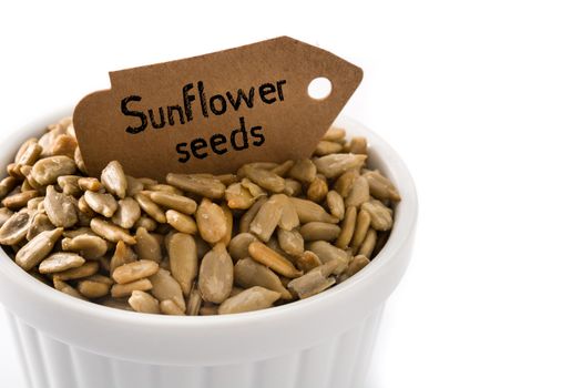 Sunflower seeds in bowl isolated on white background