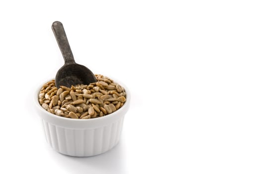 Sunflower seeds in bowl isolated on white background