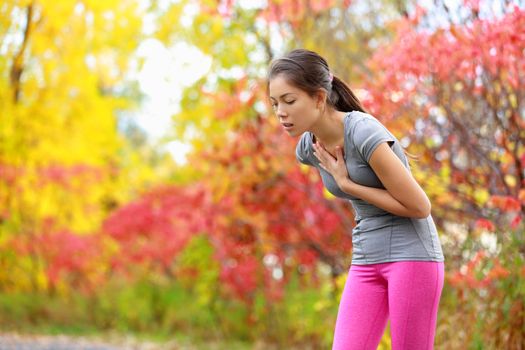 Running nausea - nauseous and sick ill runner vomiting. Running woman feeling bad about to throw up. Girl having nausea from dehydration or chest pain.