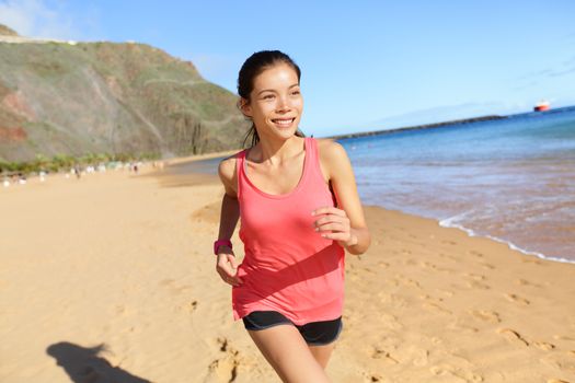 Running sports athlete runner woman on beach sweating and jogging. Fit exercising female fitness model working out training for marathon run. Biracial Asian Caucasian sports girl.