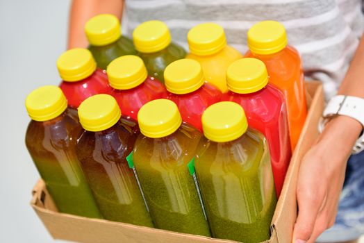 Organic cold-pressed raw vegetable juice plastic bottles. Latest food trend consisting of juicing at high pressure fresh fruits and vegetables without heating to preserve nutrients and vitamins.
