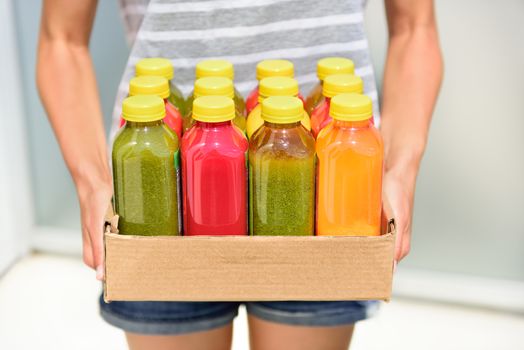 Juicing cold pressed vegetable juices for a detox diet. Dieting by cleansing your body from toxins with raw organic fruits and vegetables juice made fresh and delivered in bottles.