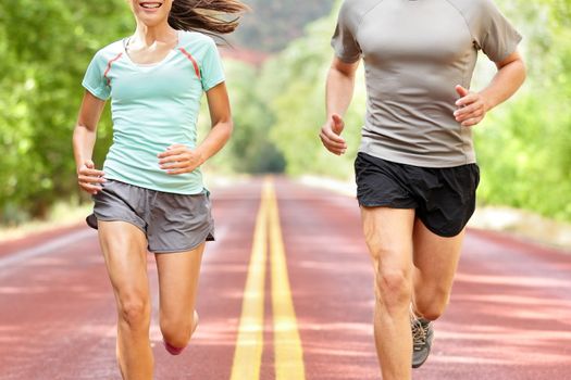 Young couple running on road.