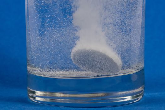 Effervescent tablet dissolving in a glass of water