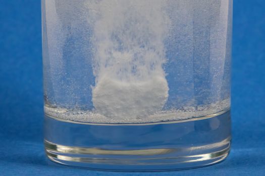 Effervescent tablet dissolving in a glass of water