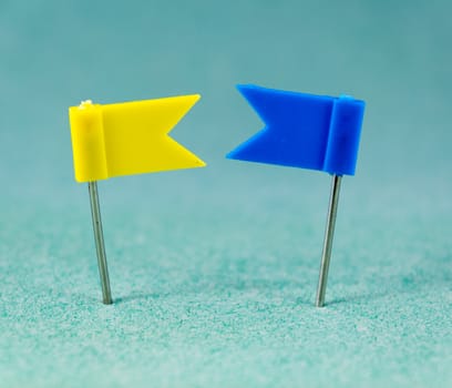 Yellow and Blue flag pins on a green background