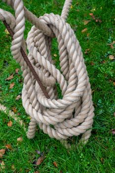 Rope coiled up onto a metal pole in a garden