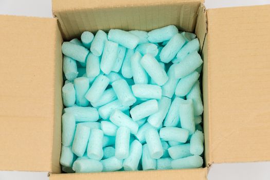 Box filled with blue styrofoam pellets