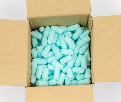 Box filled with blue styrofoam pellets