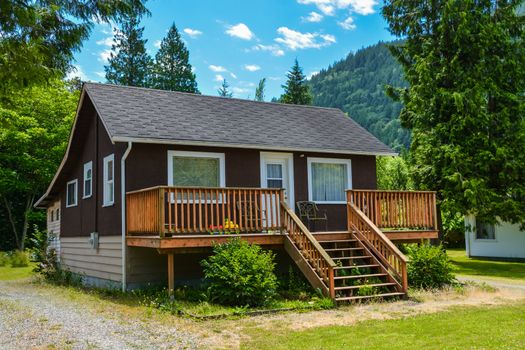 Detached single family house on country side in British Columbia, Canada. Nice house with big patio in front on blue sky background