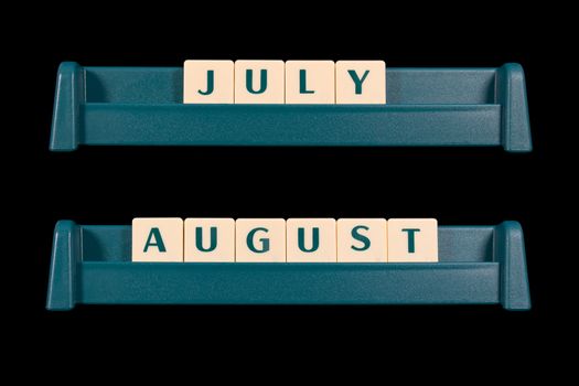 Month title made from game piece tiles. Words include July and August