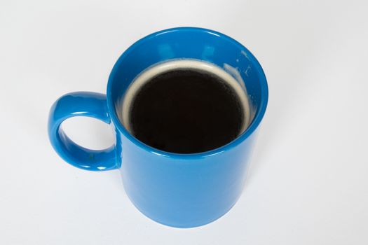 Blue mug with hot black coffee