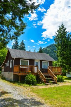 Detached single family house on country side in British Columbia, Canada. Nice house with big patio in front on blue sky background
