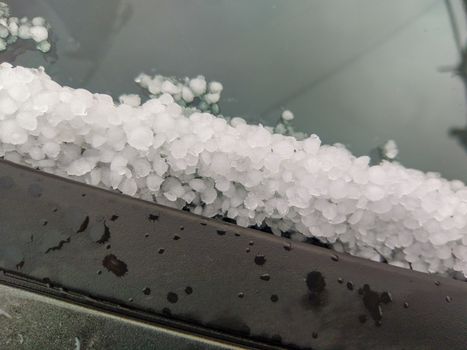 hail stones on a cars window after a storm