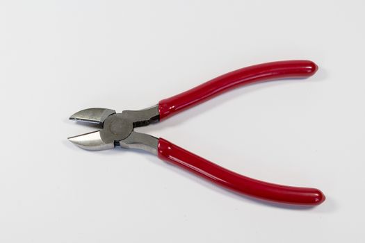 Red handle wire cutters on a white background