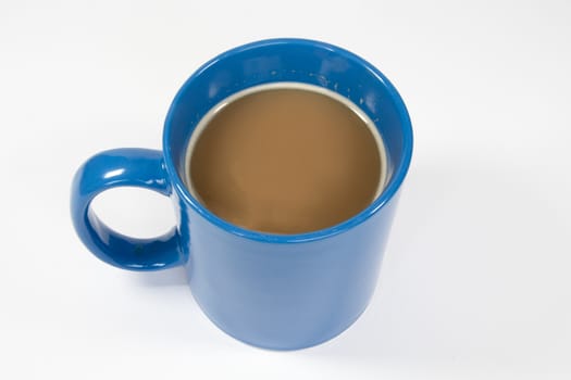 Blue mug with hot white coffee