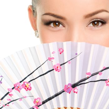 Closeup portrait of young woman with folding fan. Mixed race Asian / Caucasian female is with brown eyes. She is isolated over white background.
