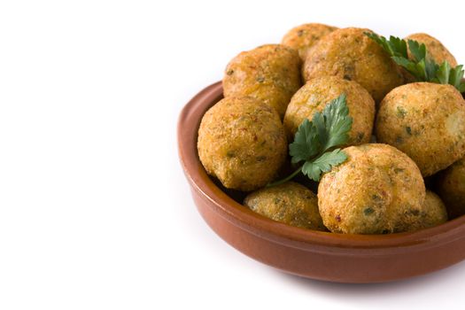 Traditional cod fritters decorated with garlic and parsley isolated on white background