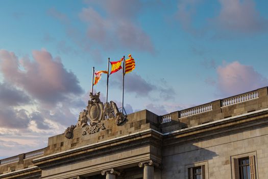 Spanish and Catalonian Flags on Stone Crest of Government Building