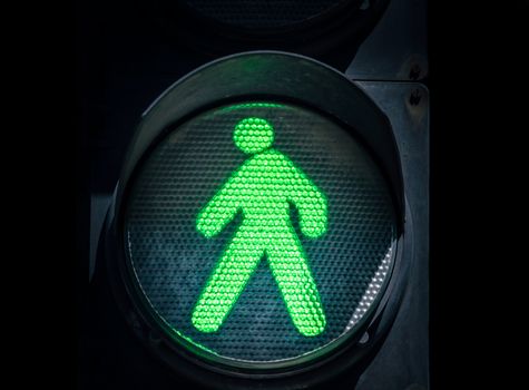 traffic light with green man on a black background abstract urban