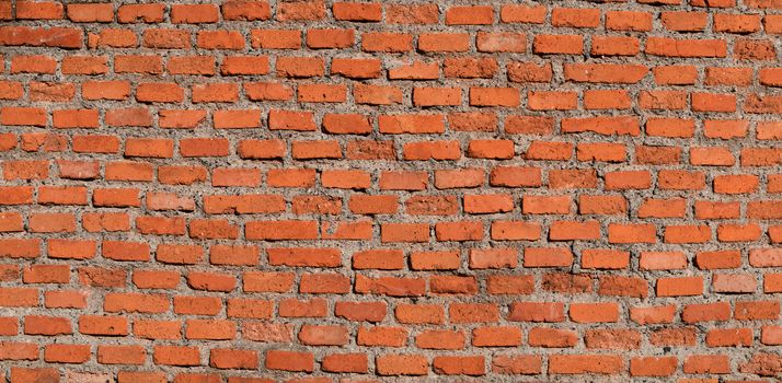 The red brick wall, rough and irregular background. Brick texture.