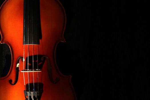 Nice violin closeup on black background under beam of light