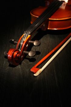Nice violin and bow on dark wooden background