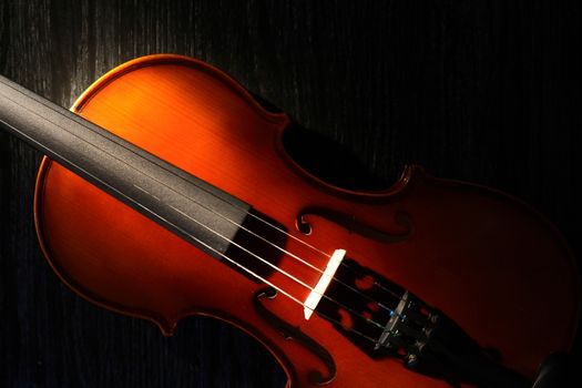 Nice violin closeup on black background under beam of light