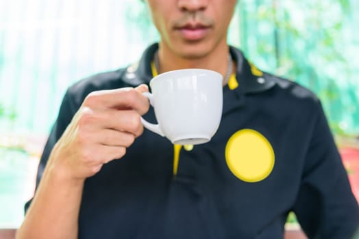 The man hold  hot coffee cup for drink