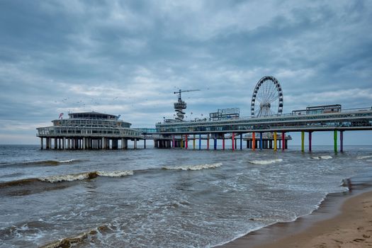 The Scheveningen Pier Strandweg, beach resort on North sea in The Hague Den Haag with Ferris wheel. The Hague, Netherlands