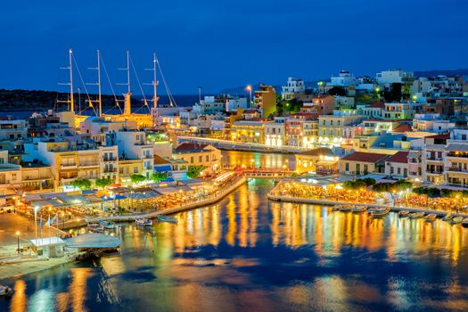 Beautiful Agios Nikolaos town on lake Voulismeni at night. Lasithi region of Crete island, Greece