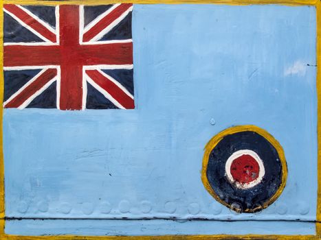 Royal Air Force roundel and Union Jack flag emblem of the United Kingdom painted on an old texture metal background