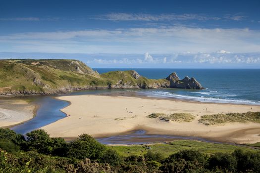 Three Cliffs Bay on the Gower Peninsular West Glamorgan Wales UK which is a popular Welsh coastline attraction of outstanding beauty