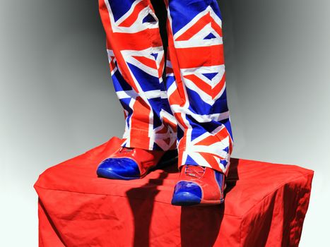 Street performer wearing trousers and shoes of the Union Jack flag of the UK in London England