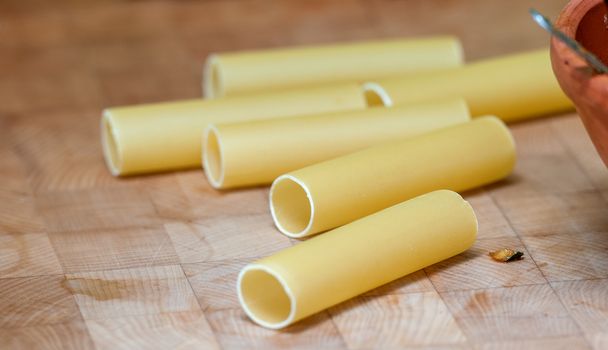 dried pasta tubes on a table top