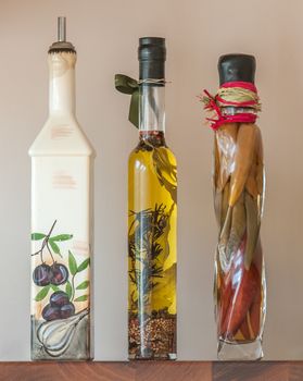 3 pretty decorative bottles on kitchen shelf