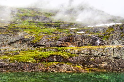 Norway landscapes. Beautiful mountainous landscape around Norwegian fjord in sunny day. Beautiful Nature Norway natural landscape. Stones boulders covered with moss.