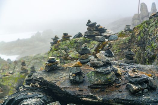 Stones stacked for Norwegian fairytale trolls. Relief and texture of stone with patterns and moss. Stone natural background. Stone with Moss. Stones boulders covered with moss.