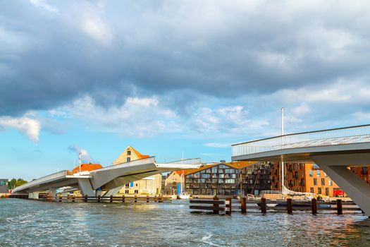 Drawbridge in Copenhagen, Denmark. Cityscape of Copenhagen, view on the drawbridge leading to popular street of Nyhavn in Copenhagen. A modern drawbridge in central Copenhagen near Nyhavn pier.