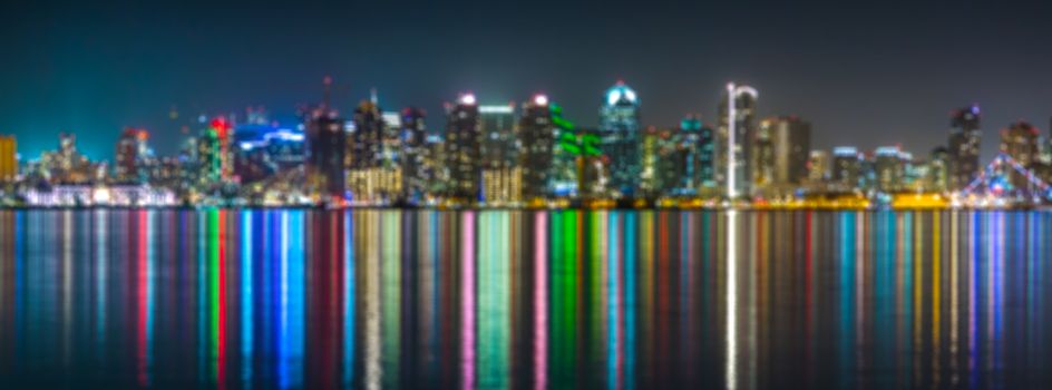 Downtown San Diego at night soft focus. San Diego skyline, night, water reflections, blured background. Skyline of San Diego at night with reflection in the water.