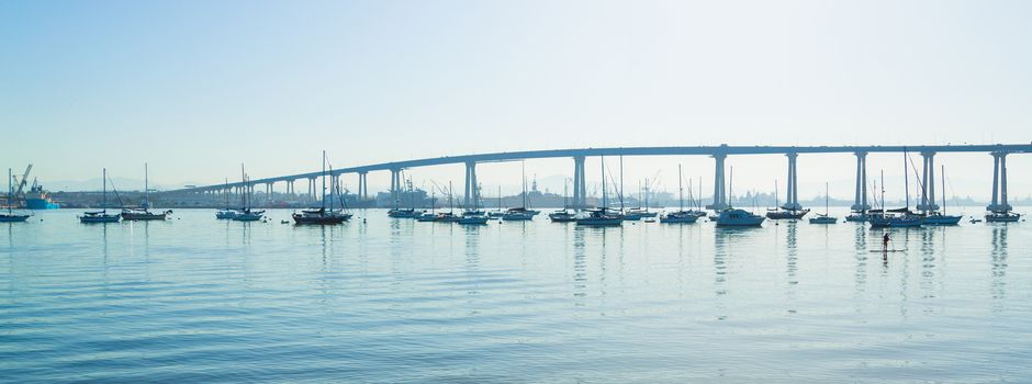 San Diego Coronado Bridge. San Diego waterfront with sailing Boats - Industrial harbor and Coronado Bridge.