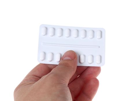 A male hand giving pills isolated against white background 
