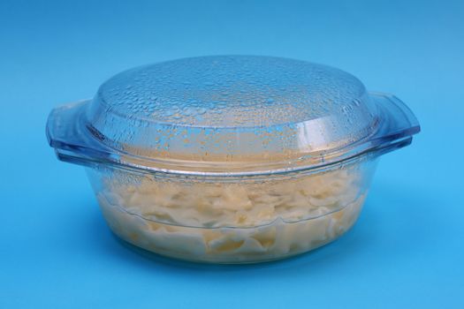 Raw pasta in a glass dish.