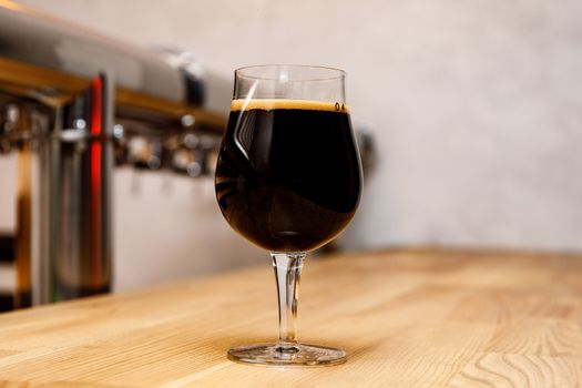 Beer glass in bar interior. Craft in pub