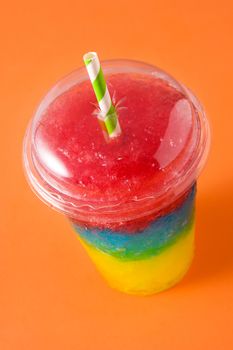 Colorful slushie of differents flavors on orange background