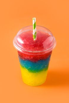 Colorful slushie of differents flavors on orange background